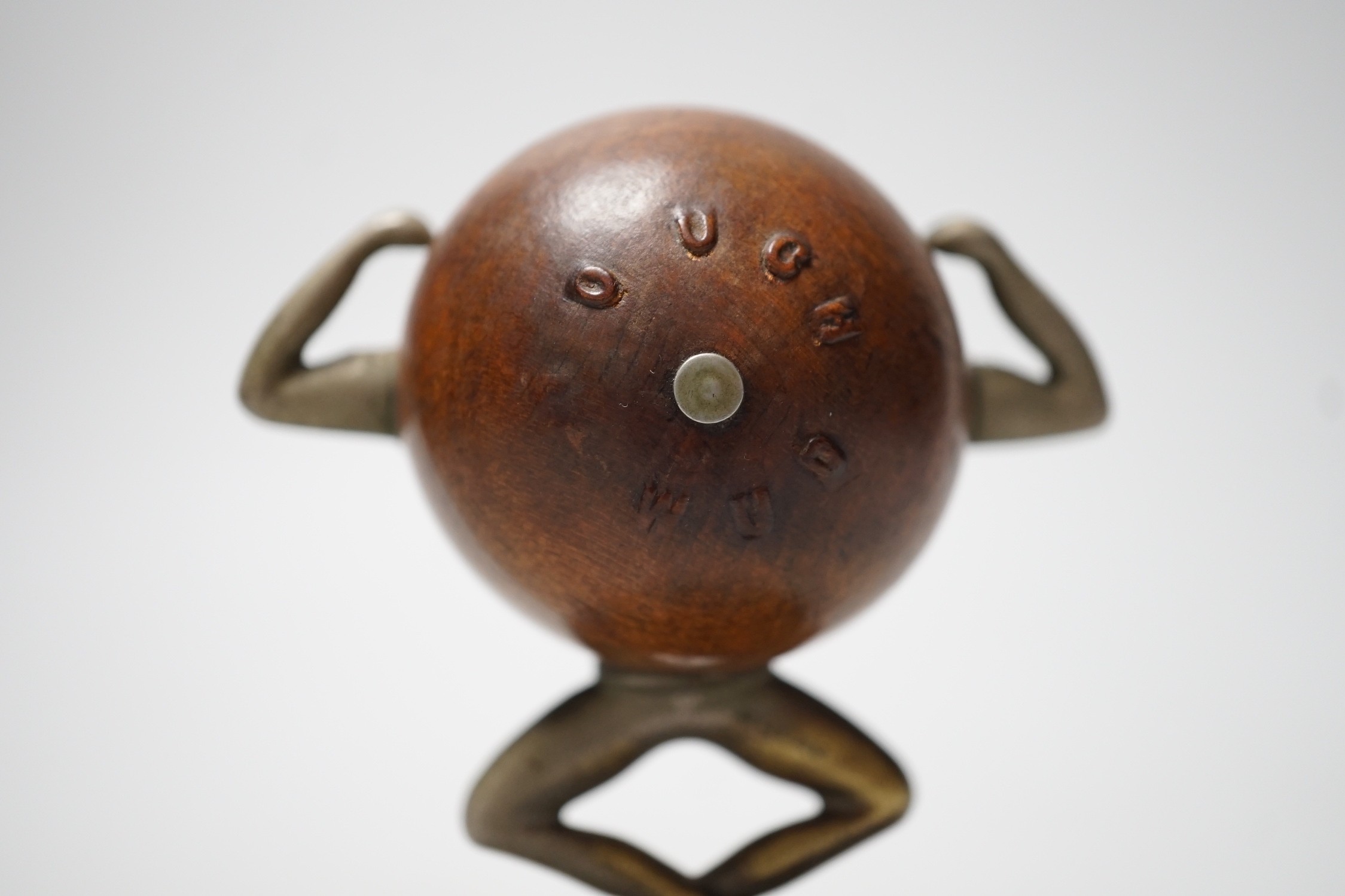 An early 20th century 'Touch Wud' figure, on an ebonised plinth 11cm tall
